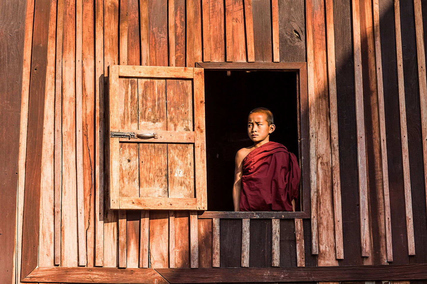 Young monk at a wooden temple of Shan State in Myanmar