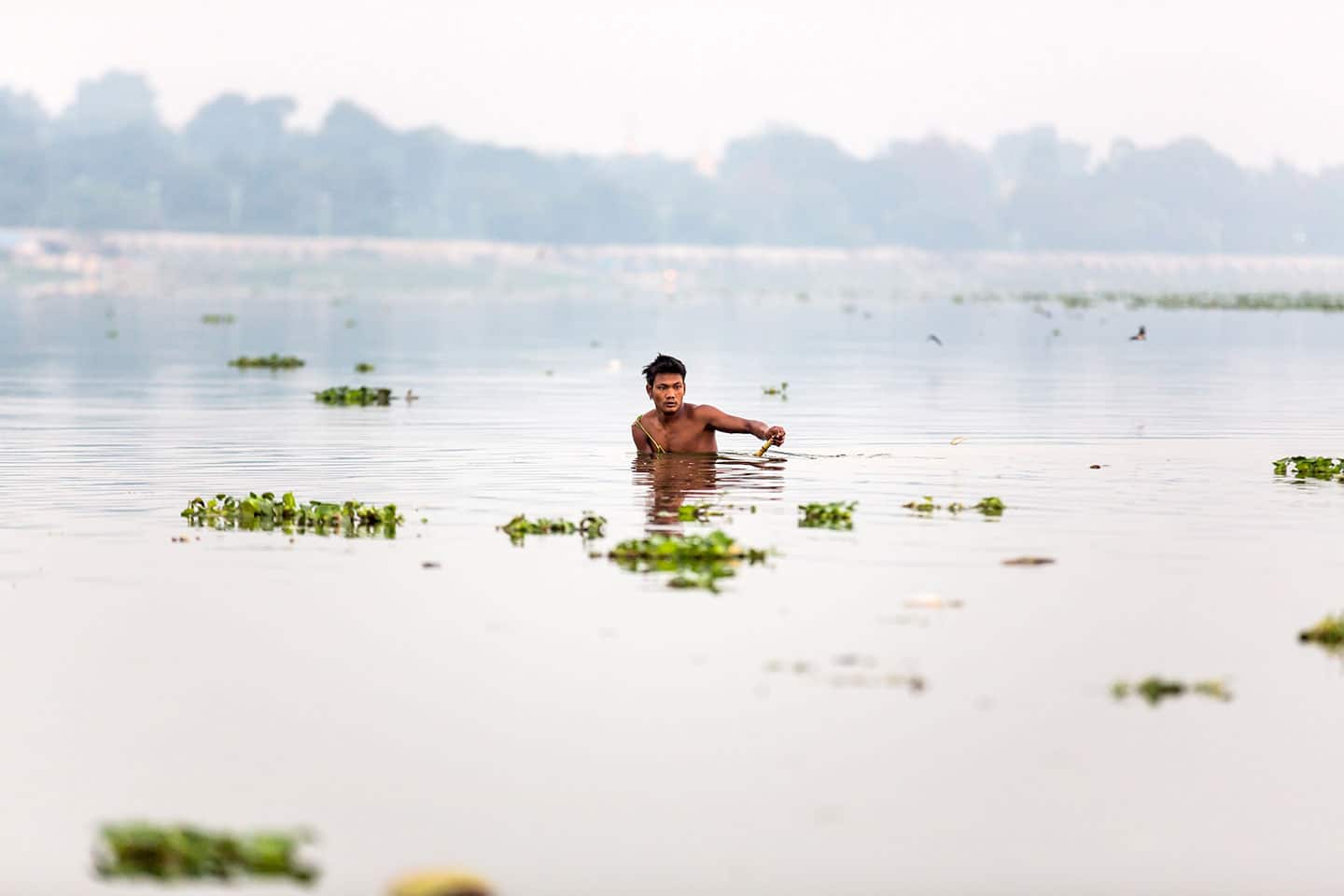 Young boy swimming in the Inle Lake in Myanmar
