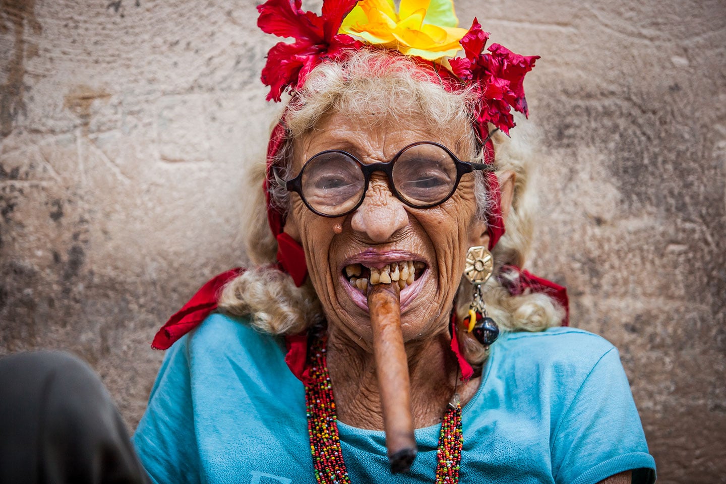 Old woman smoking a cigar on the streets of Havana, Cuba