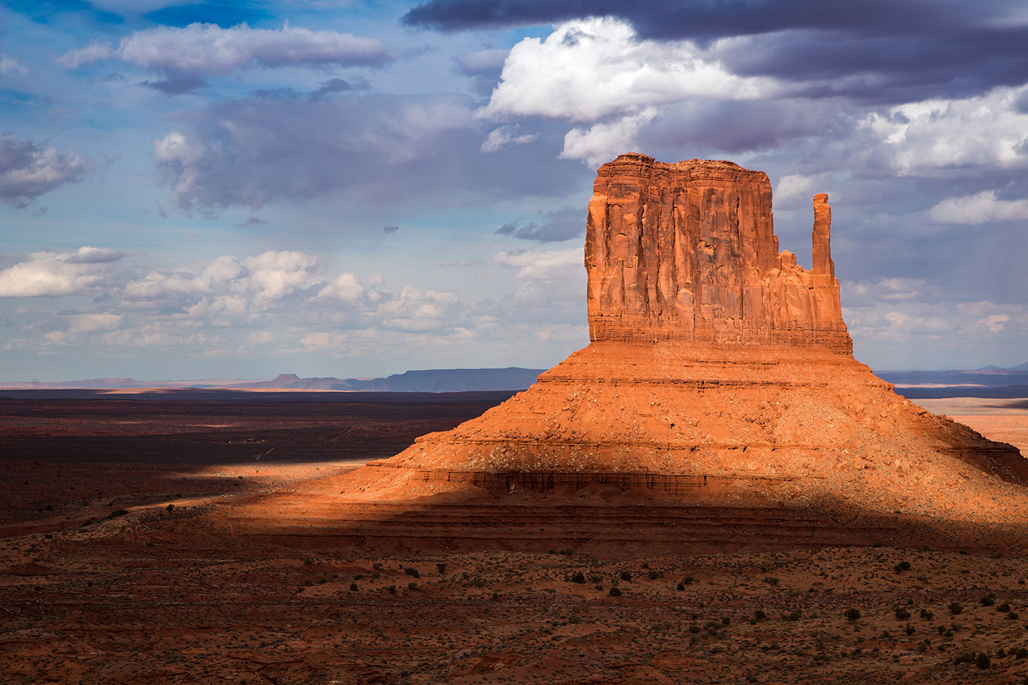 Sunlight hits a butte in Monument Valley, Arizona